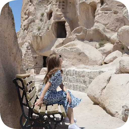 Luyao Niu seated outdoors among stone ruins